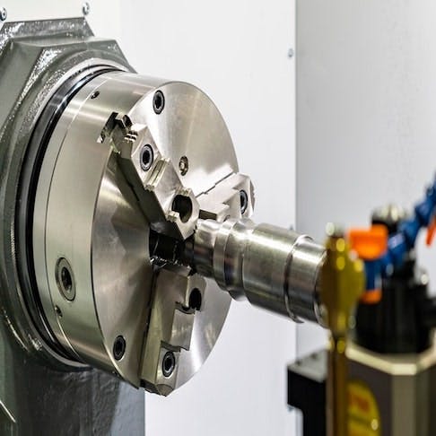 Metal part on high precision CNC lathe turning machine - Image Credit: Shutterstock/Surasak_Photo