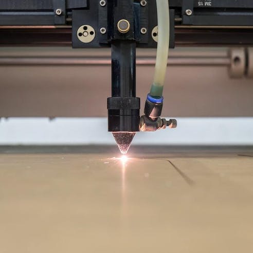 Laser cutting patterns on plastic. Image Credit: Shutterstock.com/John99