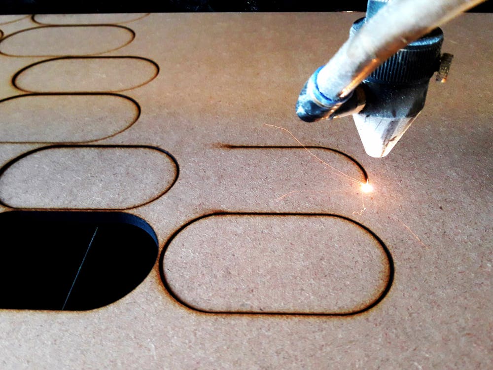 Laser cutting MDF board. Image Credit: Shutterstock.com/Edinaldo Maciel